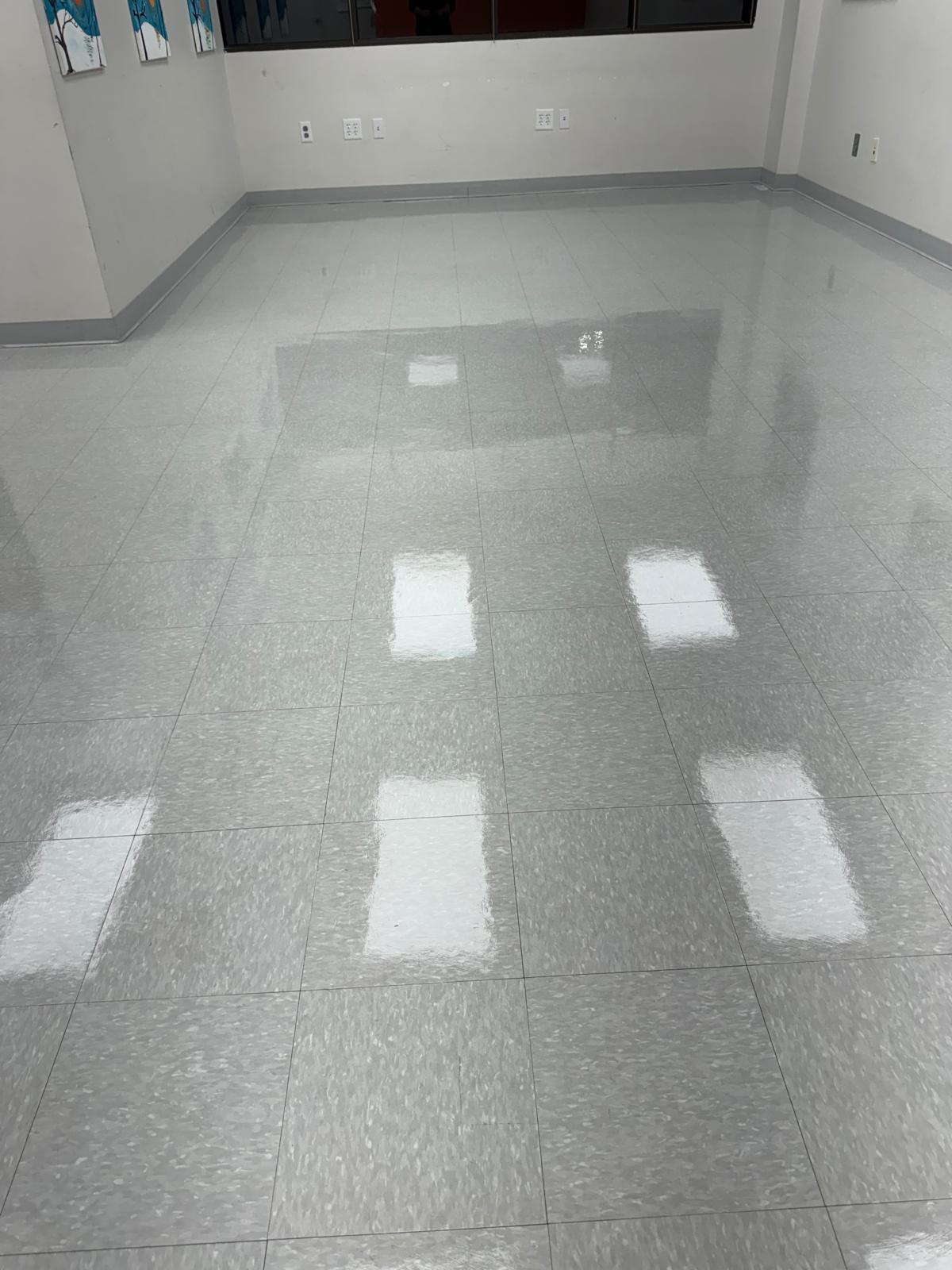 Large office room gray VCT floor after stripping and waxing