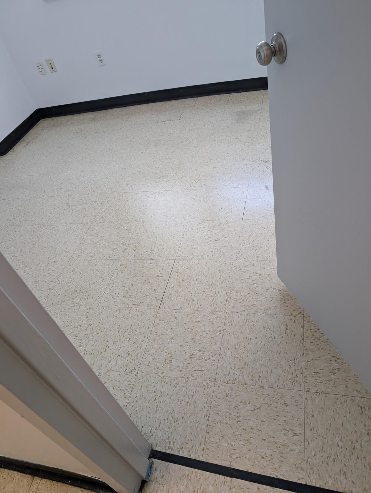 VCT tile floor before stripping and waxing - dull and worn
