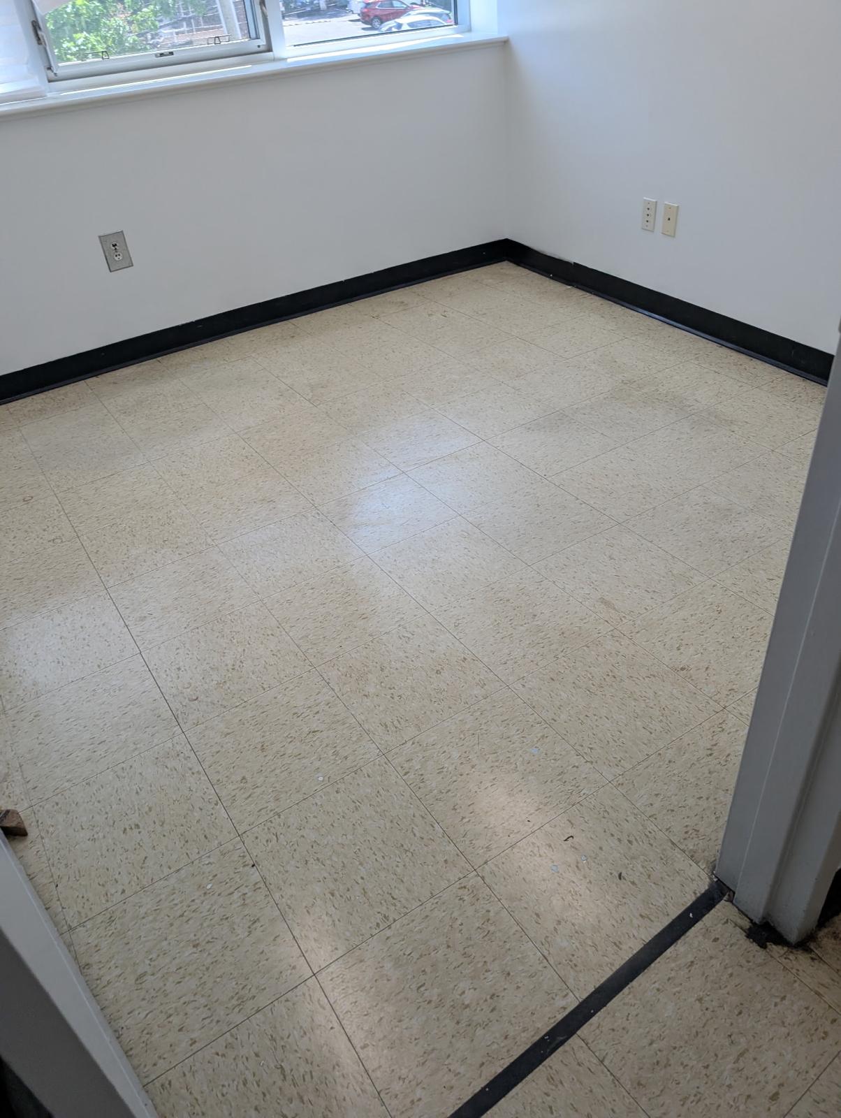 Before - dull VCT tile prior to stripping