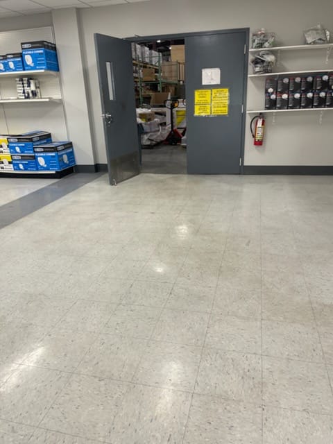 Warehouse/back-of-house commercial floor before professional buffing and burnishing